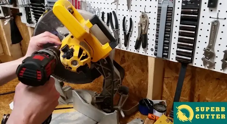 using a drill driver to open the motor of the miter saw